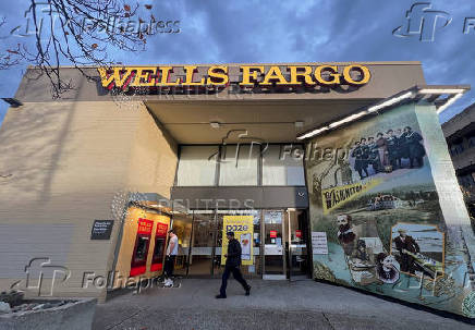 FILE PHOTO: A man walks from a branch of Wells Fargo bank in the University District of Seattle
