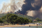 Wildfire burns in the village of Vourvourou