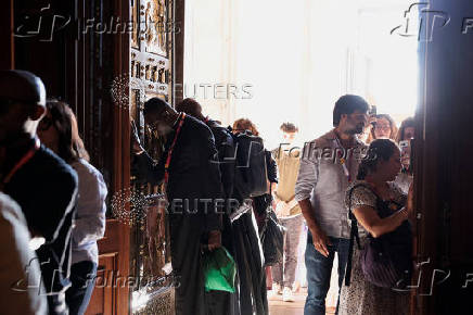 Young pilgrims pass through the Holy Door of St. Peter's Basilica during Jubilee of Youth, at the Vatican