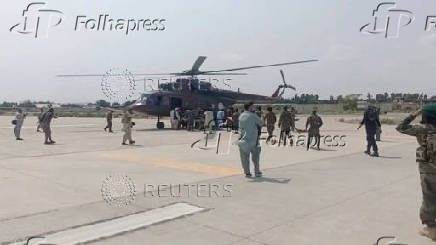 A helicopter carrying casualities lands at Nangarhar airport, in Jalalabad