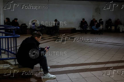 People take shelter inside a metro station during a Russian military strike in Kyiv