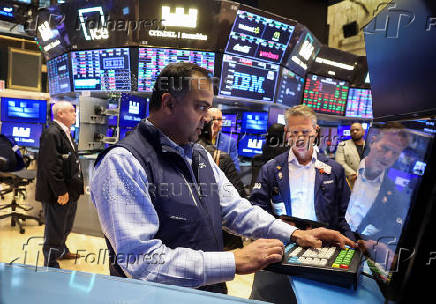 Traders work on the floor at the New York Stock Exchange, in New York City