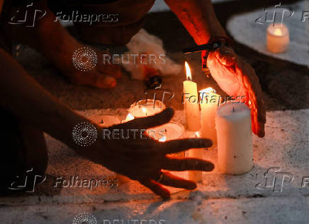Family members and friends of missing persons participate in a candlelight vigil, in Mexico City