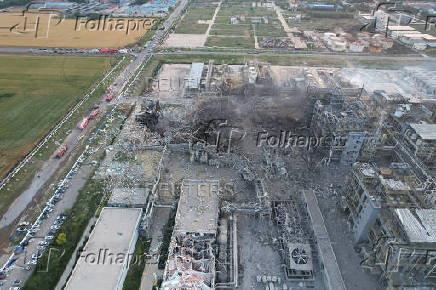 Rescuers work at the explosion site at a chemical plant in Gaomi
