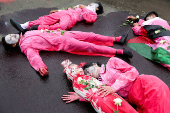 Activists stage a theatrical show during a protest against Israel and in support of Palestinians in Gaza, outside the U.S. embassy in Jakarta,