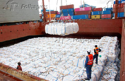 Workers unload a shipment of rice from the MV Amira Sophie II, at the Kenya Ports Authority (KPA) container terminal in the port of Mombasa