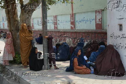 Afghan families, returned from neighboring Pakistan, receive food rations distributed by the Tawheed Charity Foundation in Jalalabad