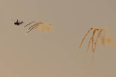 An Israeli Apache helicopter releases flares as it flies over northern Gaza