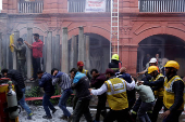 People participate in a civil defence mock drill inside the premises of an office complex in Srinagar