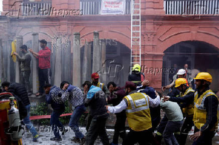 People participate in a civil defence mock drill inside the premises of an office complex in Srinagar