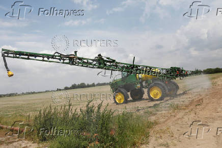 FILE PHOTO: A fertilising vehicle makes its way across crops outside Gideon, Missouri, U.S.