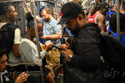 People sit on a train after watching the Chicago Cubs Milwaukee Brewers at Wrigley Field in Chicago, USA
