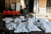 Covered bodies lie on the ground in Sweida