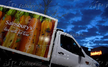 FILE PHOTO: Signage for Sainsbury's is seen on delivery vans at a branch of the supermarket in London