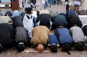 People attend an Eid al-Fitr prayer, marking the end of the Muslim holy fasting month of Ramadan in public gathering in Benghazi