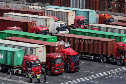 FILE PHOTO: Gantry cranes stand near shipping containers at Yangshan Port outside of Shanghai