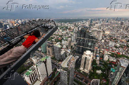 A tourist enjoys a Mahanakhon Bangkok I-Tilt in Bangkok