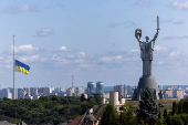 Ukrainian national flag flies at half-mast near the Ukrainian Motherland Monument after Tuesday?s deadly Russian missile strike in Kyiv