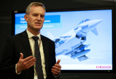 Richard Hamilton, Director for Europe and international in the Air sector of BAE Systems, gives a presentation in front of an image of one of their Typhoon military jets at their Warton factory in Warton