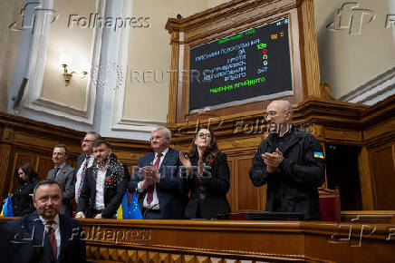 FILE PHOTO: Ukrainian Prime Minister Shmyhal, Economy Minister Svyrydenko, Foreign Minister Sybiha applause after lawmakers voted for ratification of the deal with the United States about mineral resources during a session of parliament in Kyiv