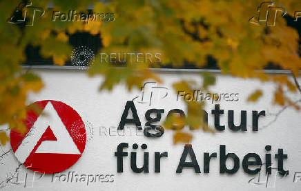 FILE PHOTO: Autumn leaves are seen in front of a sign leading to a job centre of Germany's Federal Labour Office in Holzkirchen