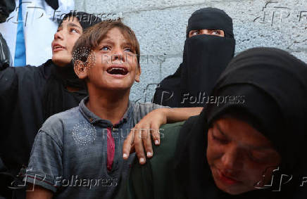 Mourners react during the funeral of Palestinians killed by Israeli fire while trying to receive aid, in Khan Younis