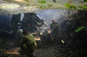 Ukrainian servicemen fire a self-propelled howitzer towards Russian troops at a frontline near the town of Chasiv Yar