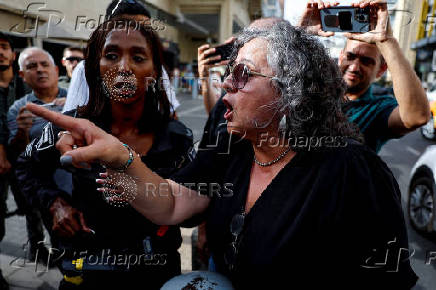 People take part in a protest against what organizers call 