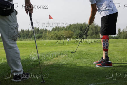 Ukrainian war veterans take part in a golf tournament outside of Kyiv