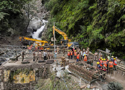 A drone view of BRO and SDRF officials attempting to build a makeshift bridge in Gangnani