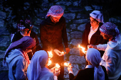 Iraqi Yazidis attend a ceremony on the occasion of Red Wednesday, to celebrate the Yazidi New Year, at Lalish temple in Shekhan District near Duhok province
