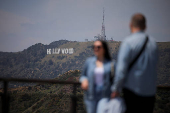 Visitors take photos with the Hollywood sign from the Griffith Observatory in Los Angeles