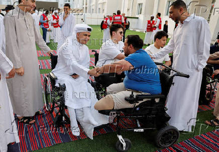 Palestinians from Gaza attend Eid al-Adha prayers, at Al Thumama Complex,  in Doha