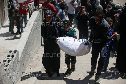 Palestinians gather to receive aid supplies at a distribution center, in Gaza City