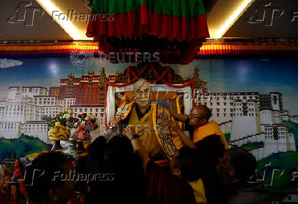 Tibetans mark the 90th birthday celebration of their spiritual leader, the Dalai Lama, at Jawalakhel Handicraft Center in Lalitpur