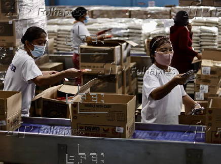 President Ferdinand Marcos visits a relief goods warehouse in Manila as Tropical Storm 'Crising apporaches