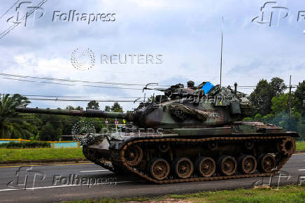 A tank drives on a road toward Thailand-Cambodia's border in Sisaket province, ahead of a ceasefire talks in Malaysia on the deadly border conflict between Thailand and Cambodia