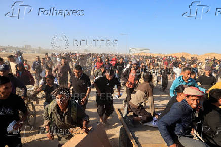 Palestinians receive aid from the U.S.-backed Gaza Humanitarian Foundation, in Khan Younis