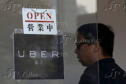 FILE PHOTO: An open sign is seen at the office of taxi-hailing service Uber Inc during a driver recruitment event in Hong Kong