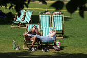 People enjoy the sunny weather in London