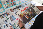 A man holds a newspaper with a cover photo of U.S. President Donald Trump and U.S. Middle East envoy Steve Witkoff, in Tehran