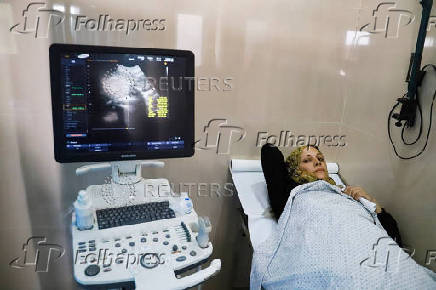 Fatima Arafa, a pregnant and displaced Palestinian woman, undergoes medical check up at Al-Helou hospital, in Gaza City