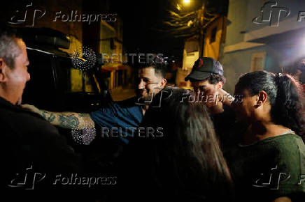 Arturo Suarez, who was held for months in an El Salvador prison, greets family members after his release, in Caracas