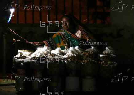 Street vendor sells dry fruits on a roadside in Karachi