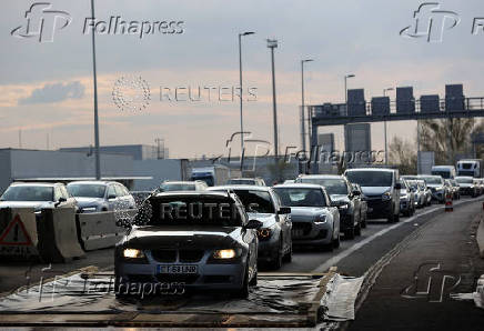 Cars drive through a disinfectant mat during the outbreak of foot-and-mouth disease at the Austiran-Hungarian border