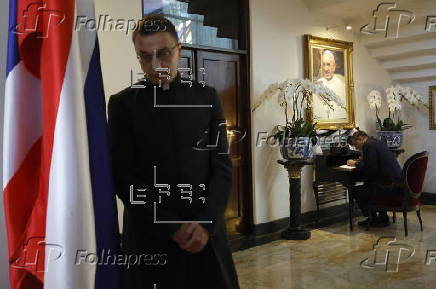 People sign condolence book at Vatican embassy in Bangkok following Pope Francis's death