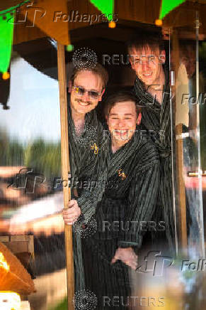 Members of the band KAJ pose in the sauna of the BastutiBasel fan project in Basel