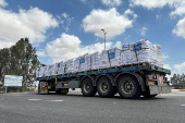Trucks carrying aid are seen at the Kerem Shalom crossing between Israel and Gaza, on its Israeli side
