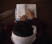 Student reads the Koran at a madrasa in Multan