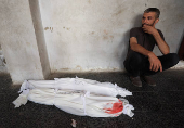 Mourners react near the bodies of Palestinians killed in an Israeli strike, in Gaza City